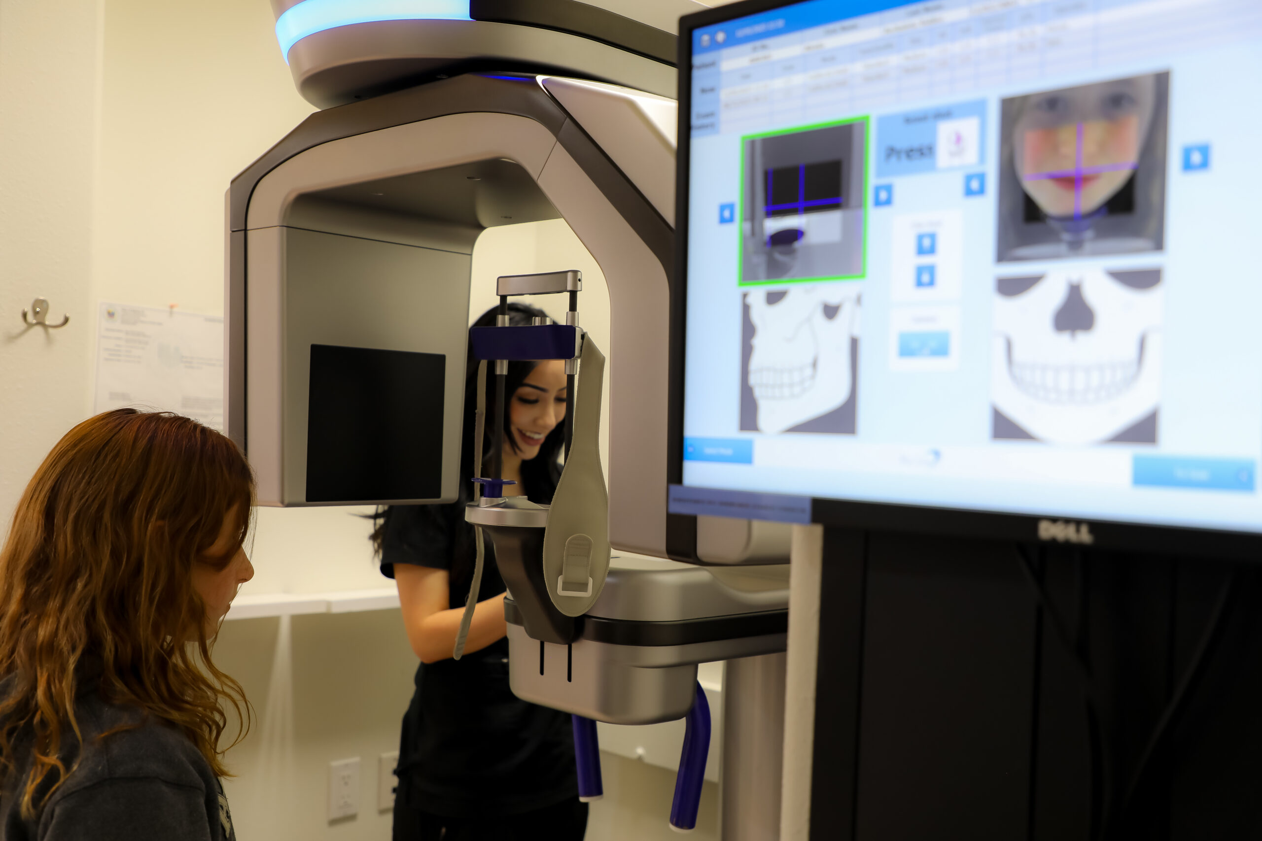 ilagro Dental 3D Scanning 914 A dental assistant at Milagro Dental in Santa Fe, New Mexico, prepares a young patient for a precise 3D dental scan using state-of-the-art imaging technology.